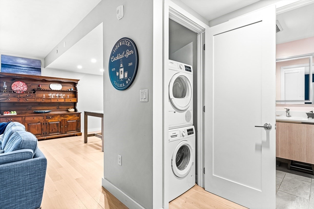932 Broadway, Unit 208 Chelsea, MA 02150 - Photo 14 of 25 a view of a storage and utility room with washer and dryer