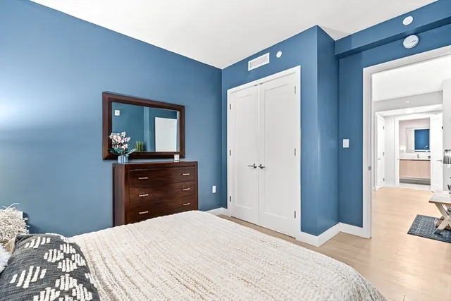 a bedroom with a bed and a dresser