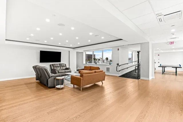 a living room with furniture flat screen tv and a table