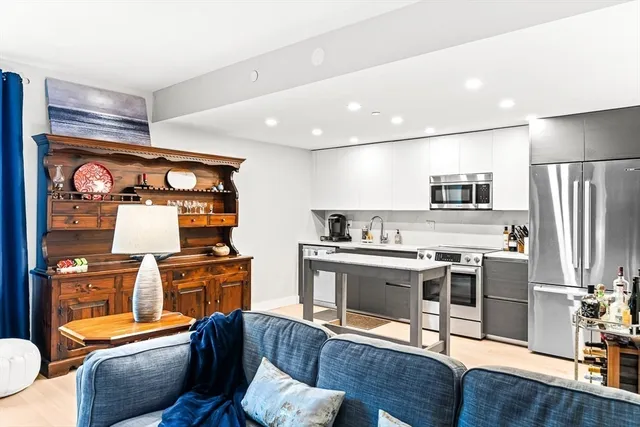 a kitchen with stainless steel appliances granite countertop a stove and a refrigerator