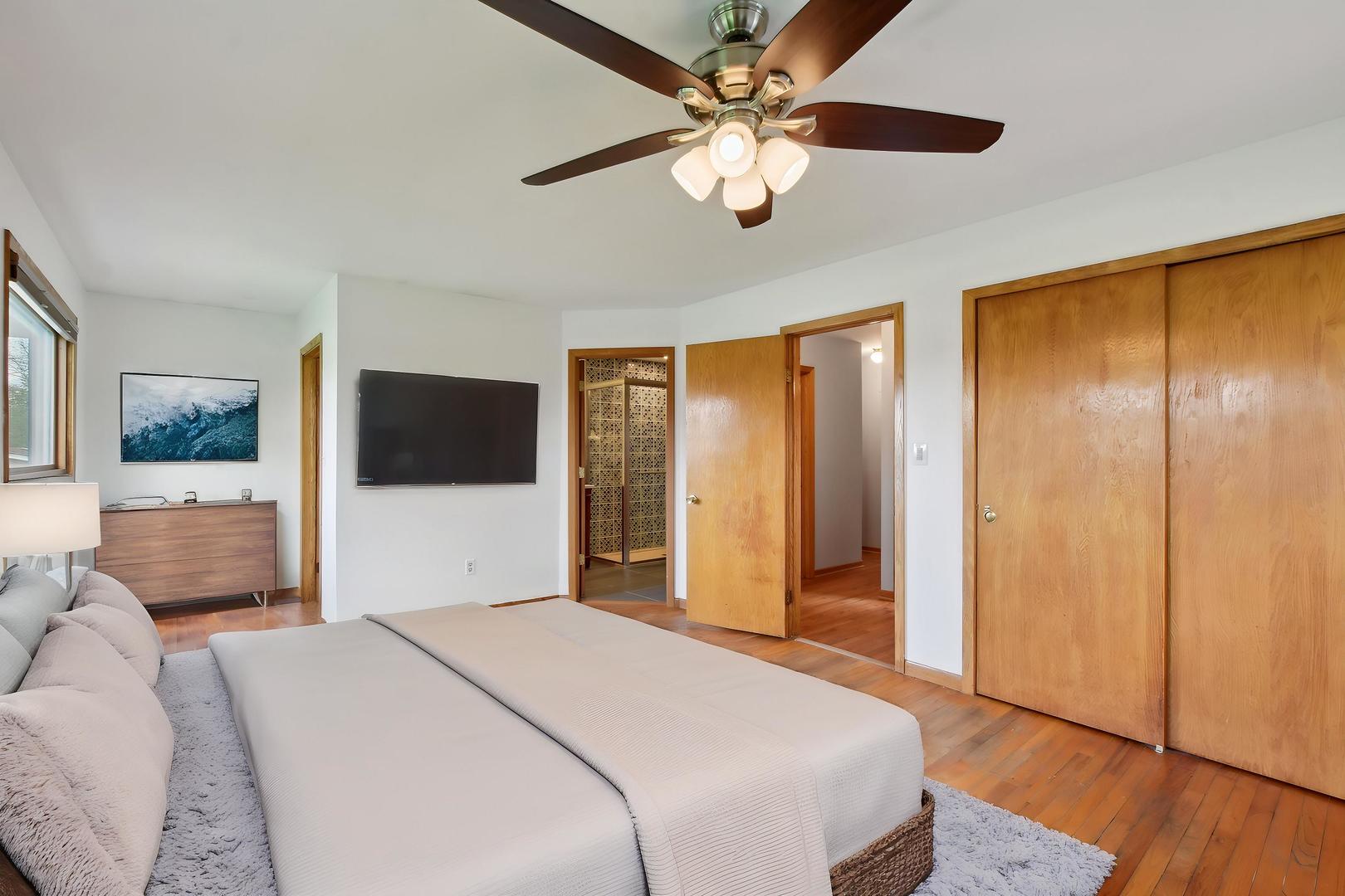 7N401 Stevens Road St. Charles, IL 60175 - Photo 15 of 33 a bedroom with a large bed and a chandelier