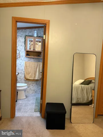 a bedroom with a bed and a mirror