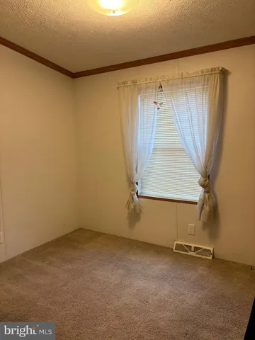 a view of a room with a wooden floor and a window