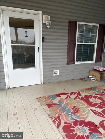a front view of a house with a rug