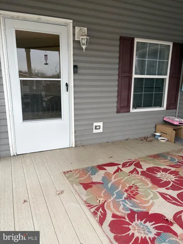 a front view of a house with a rug