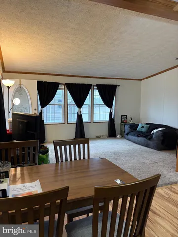 a view of livingroom with furniture and workspace