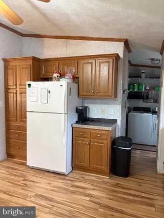 a kitchen with a refrigerator and a stove
