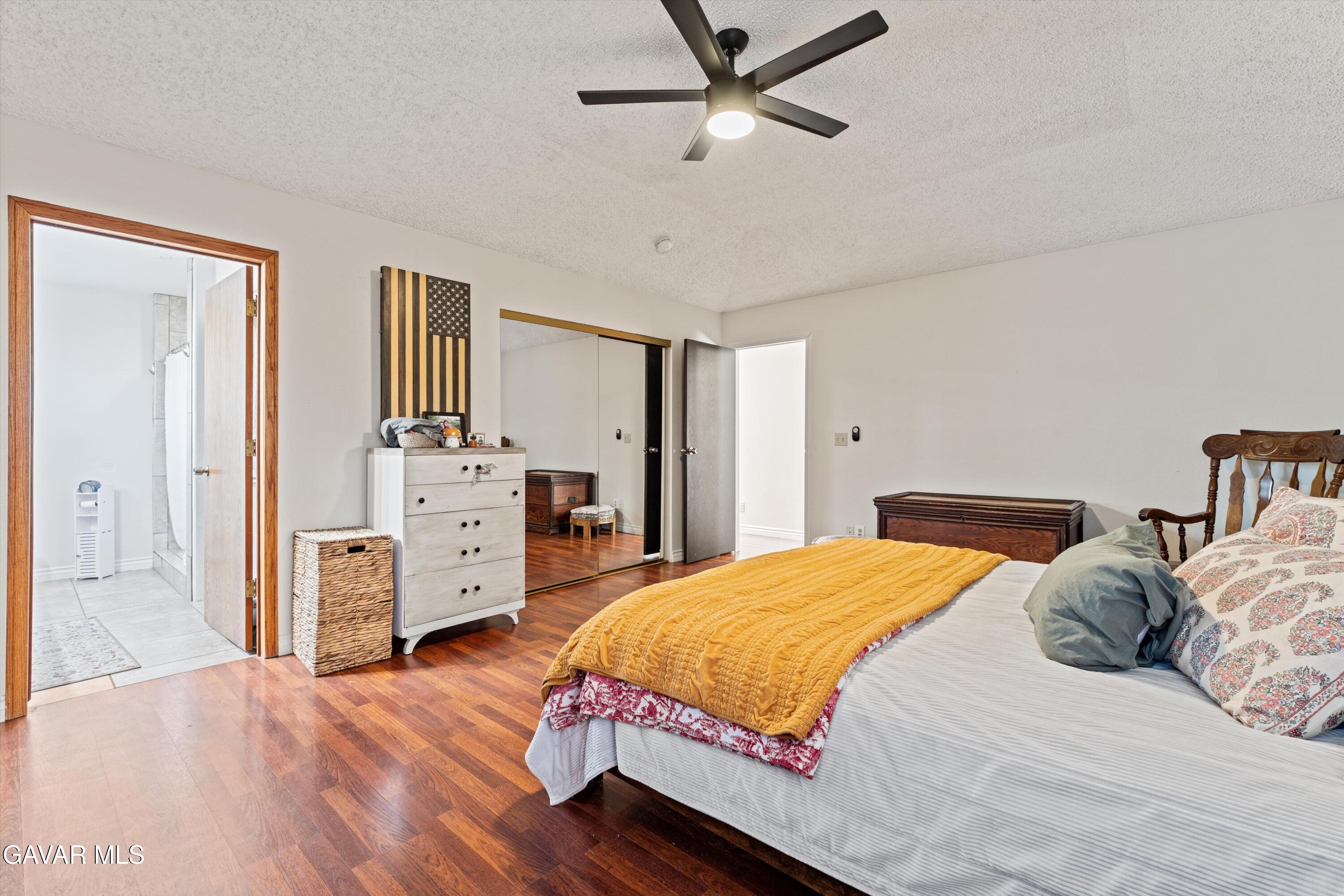 20102 Pine Ridge Drive Tehachapi, CA 93561 - Photo 11 of 48 a bedroom with a bed and wooden floor