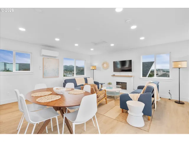 a dining room with furniture a window and a kitchen space