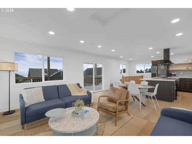 a living room with furniture and kitchen view