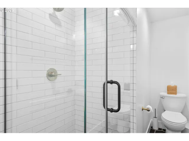 a bathroom with a toilet sink and shower