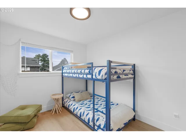 a bedroom with a bed and a painting on the wall