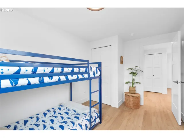 a bedroom with furniture window and wooden floor