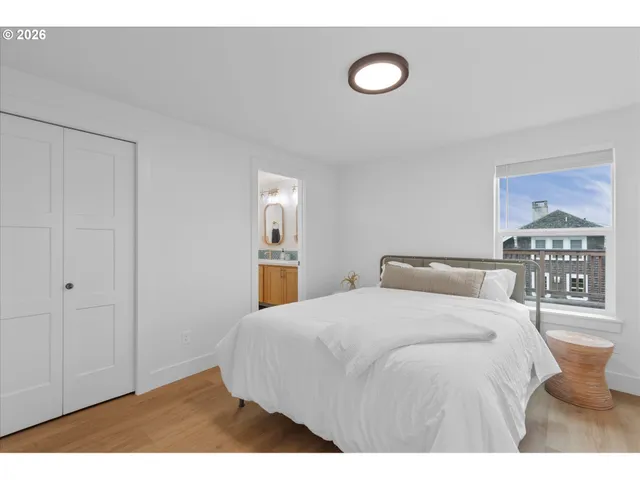 a bedroom with a bed and a lamp