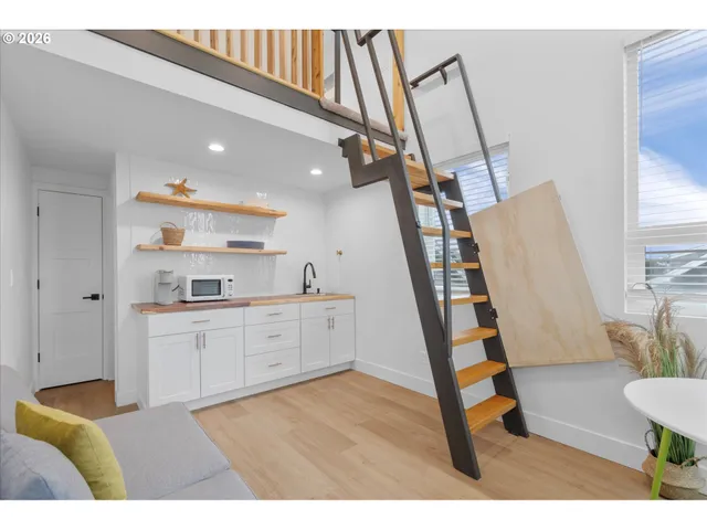 a open kitchen with cabinets a sink and wooden floor
