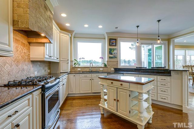 a kitchen with stainless steel appliances granite countertop a stove and a sink