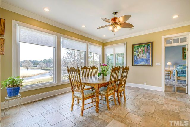 a dining room with furniture a chandelier and window