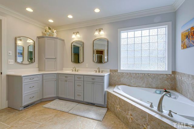 a bathroom with a granite countertop tub sink double vanity granite and a large mirror