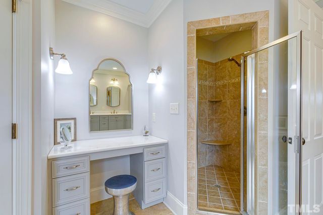 a bathroom with a sink a mirror and a shower