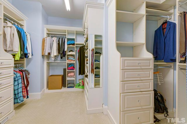 a view of walk in closet with clothes
