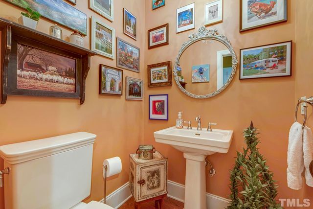 a bathroom with a sink mirror and toilet