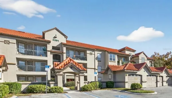 a front view of a residential apartment building with a yard
