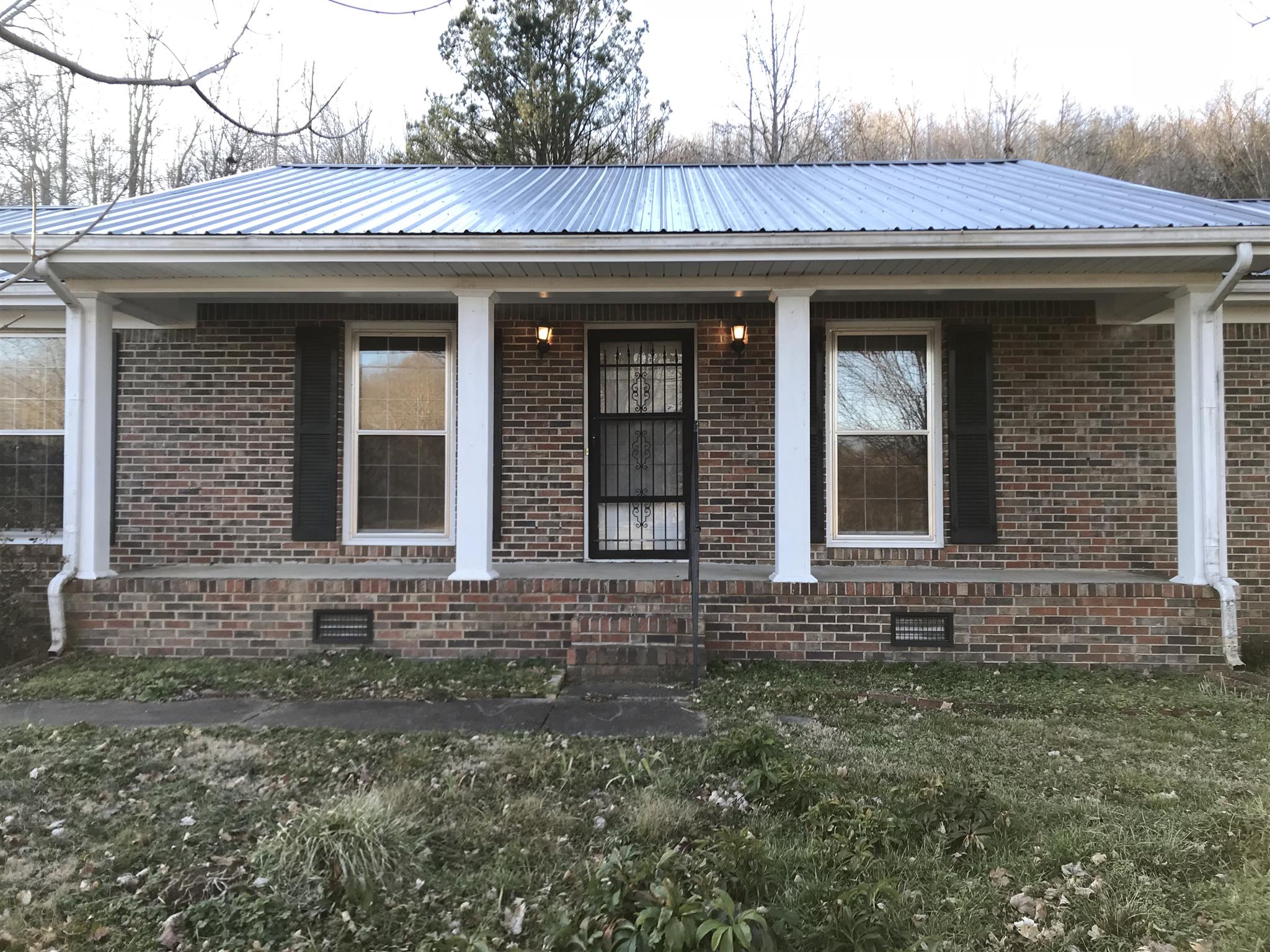 101 Hayes Road Goodspring, TN 38460 - Photo 2 of 22 a view of brick house with a large windows