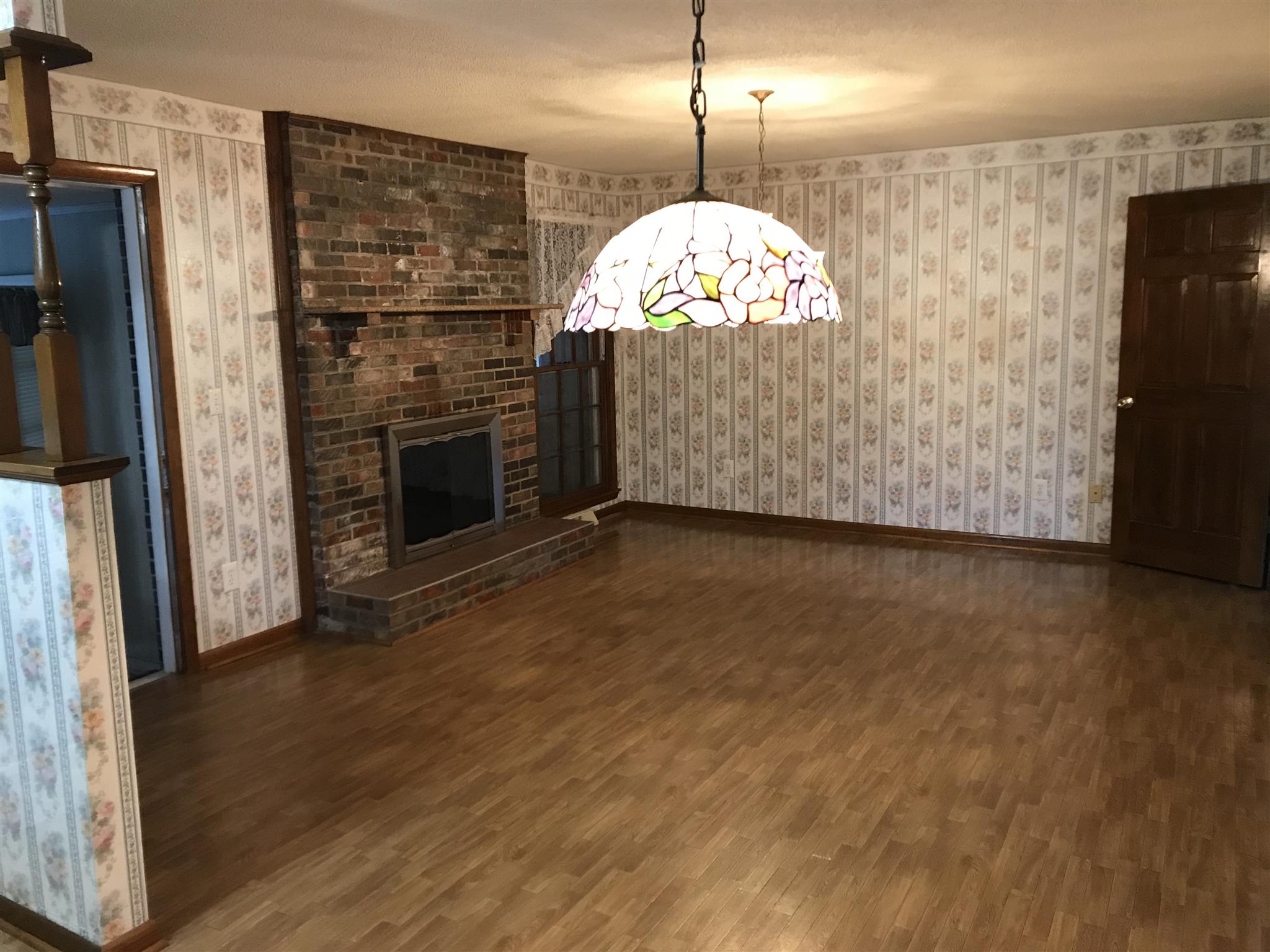 101 Hayes Road Goodspring, TN 38460 - Photo 7 of 22 a view of a livingroom with a fireplace wooden floor and staircase