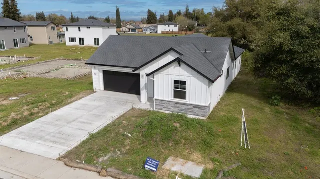 a aerial view of a house with a yard