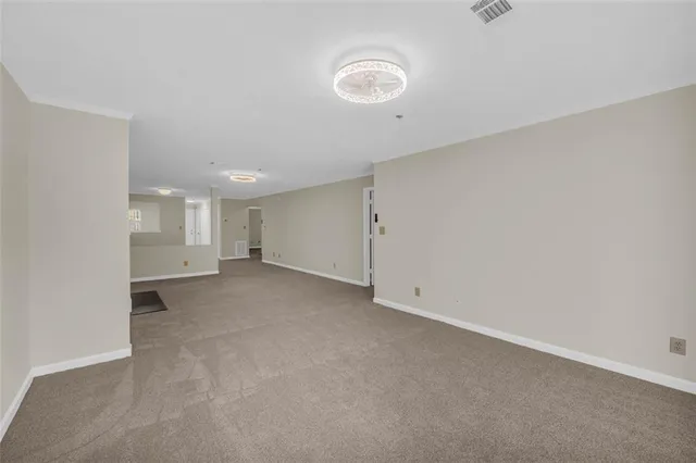 a view of an empty room with a ceiling fan
