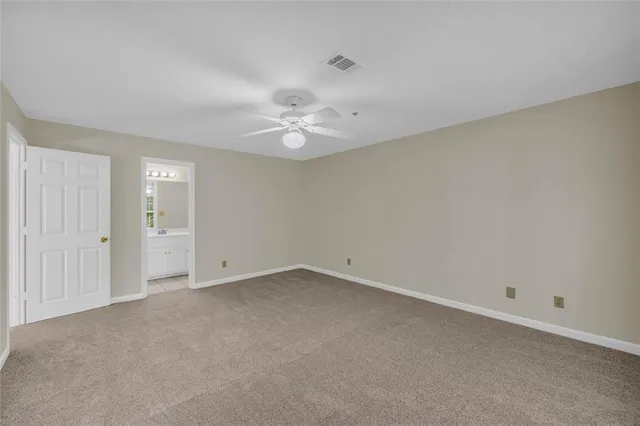 a view of an empty room with a ceiling fan