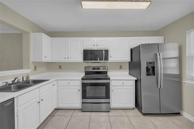 a kitchen with stainless steel appliances granite countertop a sink and a stove