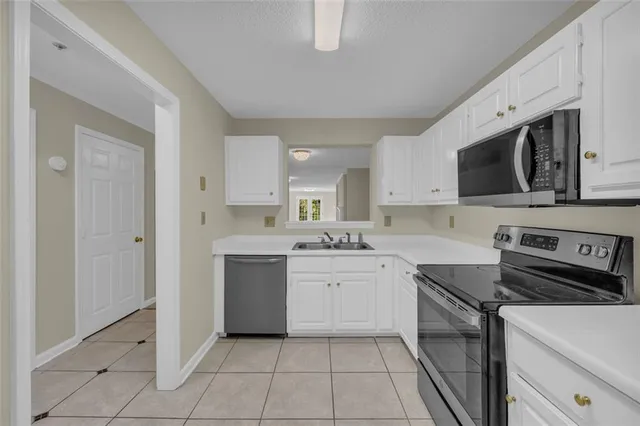 a kitchen with a refrigerator and a sink