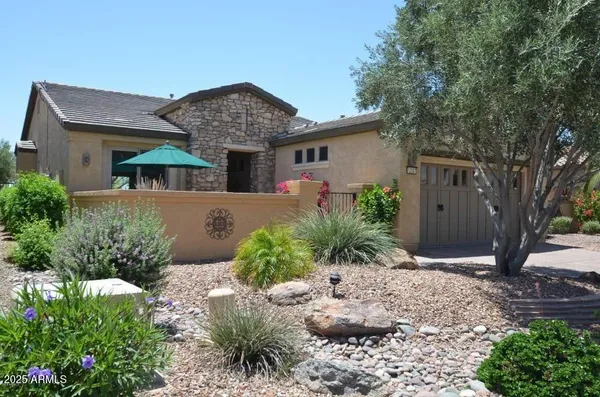 a front view of a house with garden