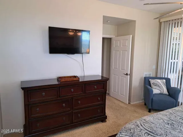 a bedroom with a bed and a table with lamp