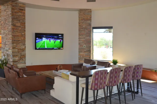 a living room with lots of furniture and wooden floor