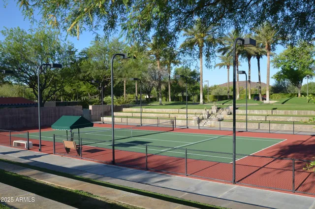 a kitchen with stainless steel appliances a dining table and chairs
