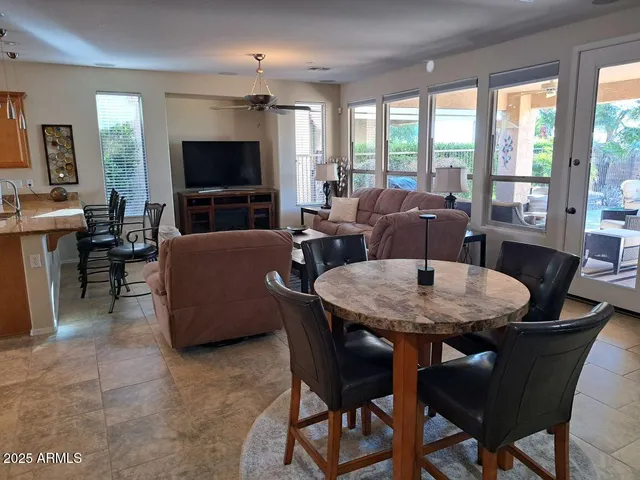 a view of a dining room with furniture window and outside view