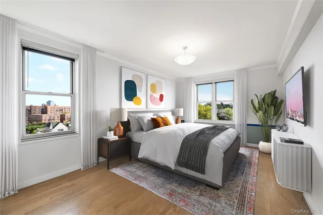 a bedroom with a bed a window and a flat screen television