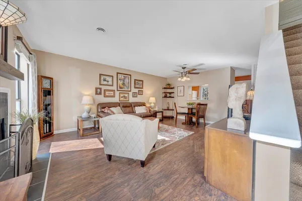 a living room with furniture and a wooden floor