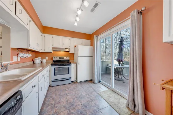 a kitchen with a sink appliances and cabinets