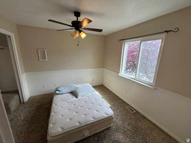432 Spring Lane Logan, UT 84341 - Photo 22 of 22 Bedroom with ceiling fan and dark colored carpet