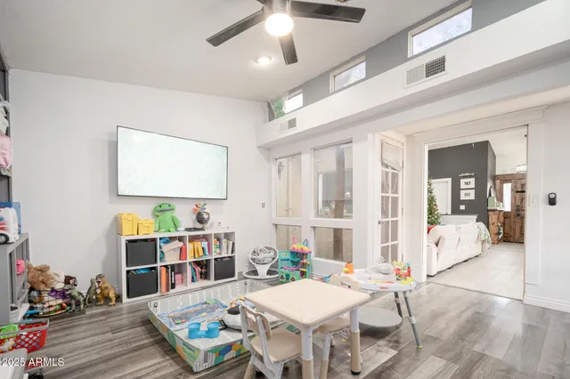 a living room with furniture and a wooden floor