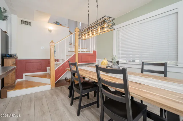 a view of entryway dining room and hall with wooden floor