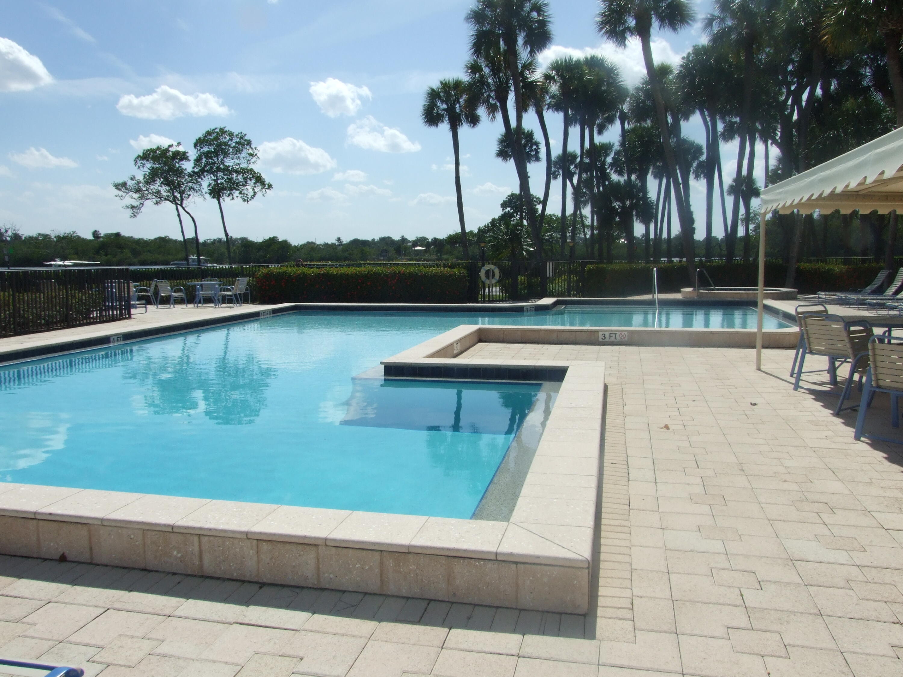 1000 North Us Highway West, Unit 809 Jupiter, FL 33477 - Photo 17 of 21 a view of swimming pool with seating space and trees in the background