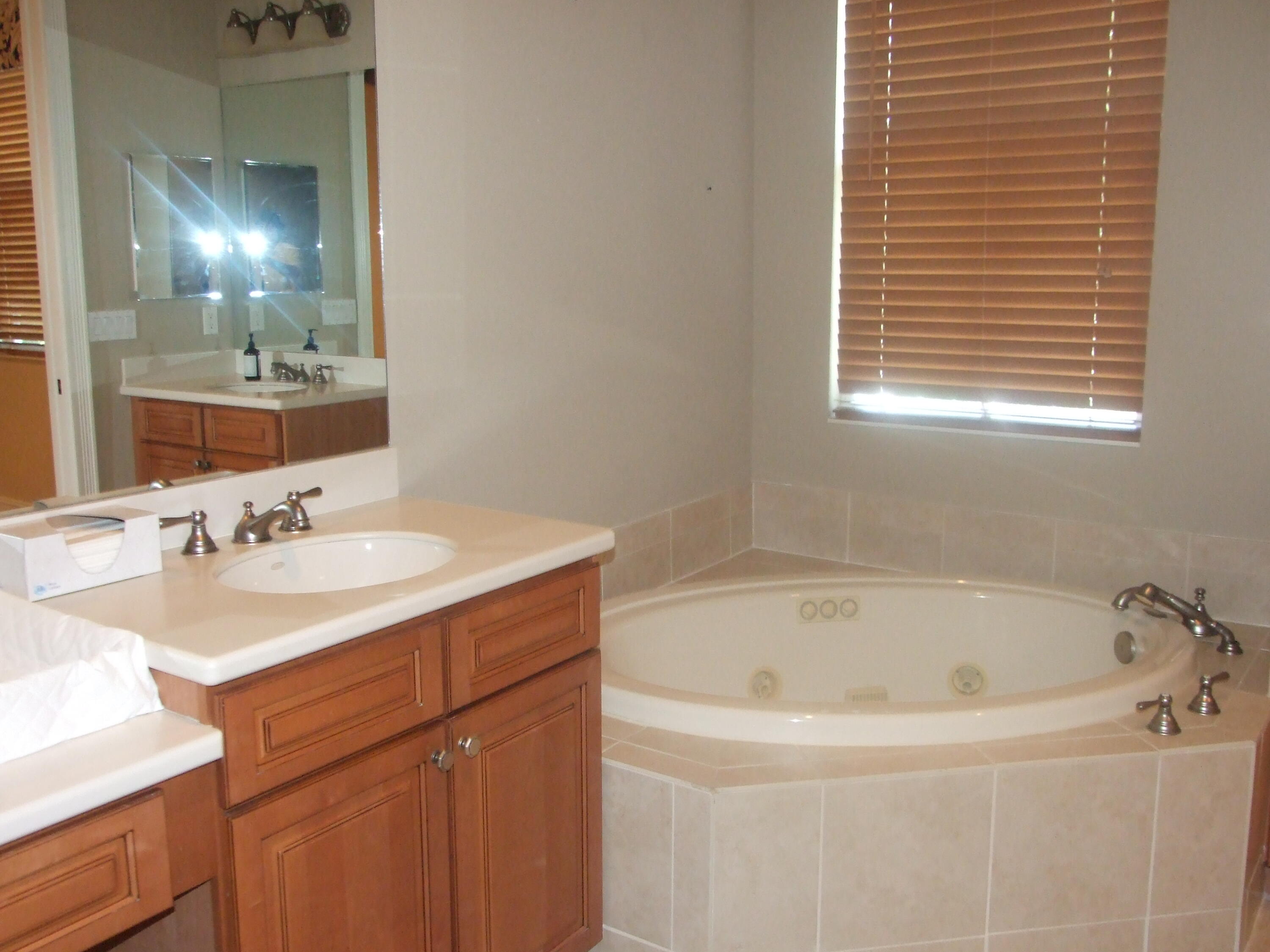 1000 North Us Highway West, Unit 809 Jupiter, FL 33477 - Photo 10 of 21 a white bath tub sitting next to a bathroom sink