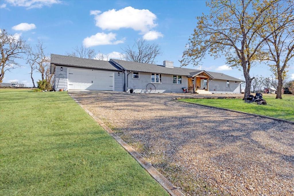 90 Williams Trail Howe, TX 75459 - Photo 16 of 18 a front view of a house with a yard and garage