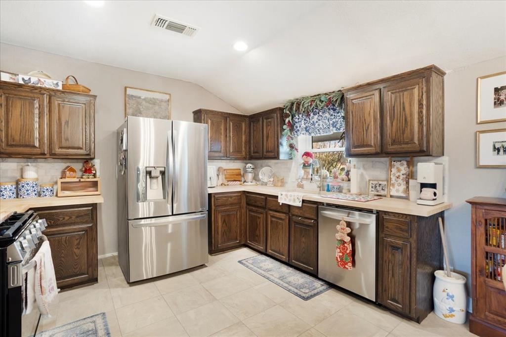 90 Williams Trail Howe, TX 75459 - Photo 2 of 18 a kitchen with stainless steel appliances granite countertop a refrigerator stove a sink and dishwasher