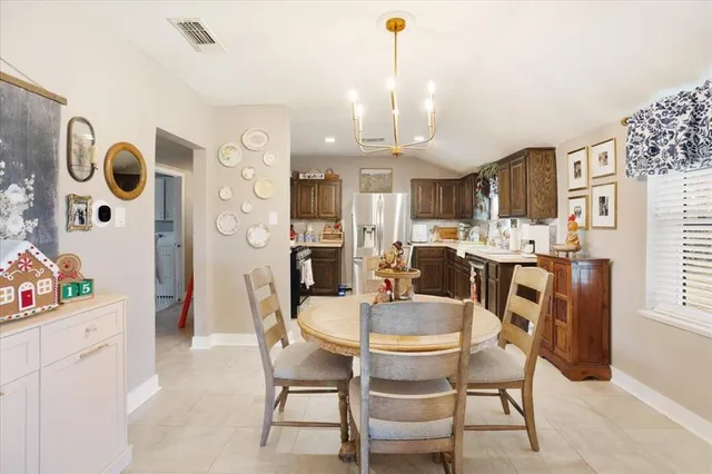 a dining room with furniture and kitchen view