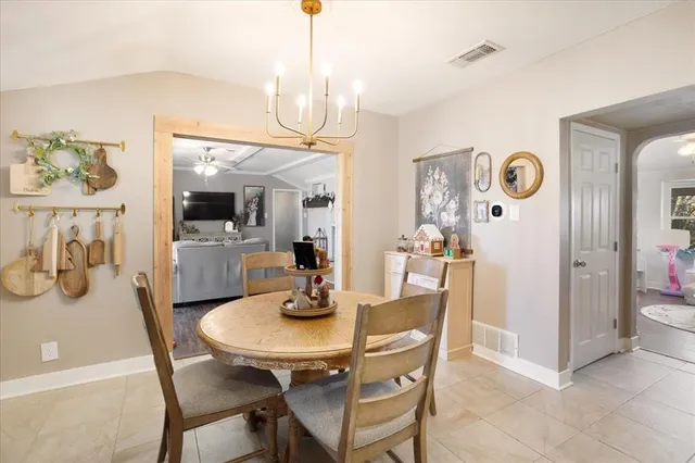 a view of a dining room with furniture and chandelier